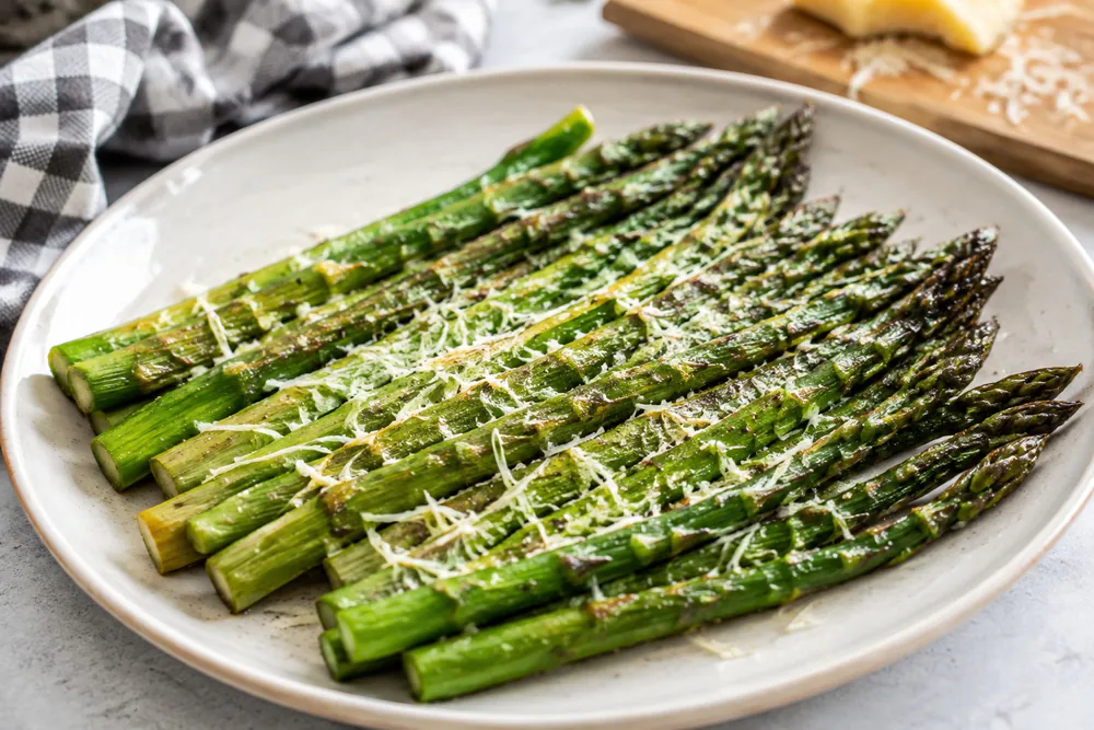 Asparagus spears topped with parmesan after air frying.