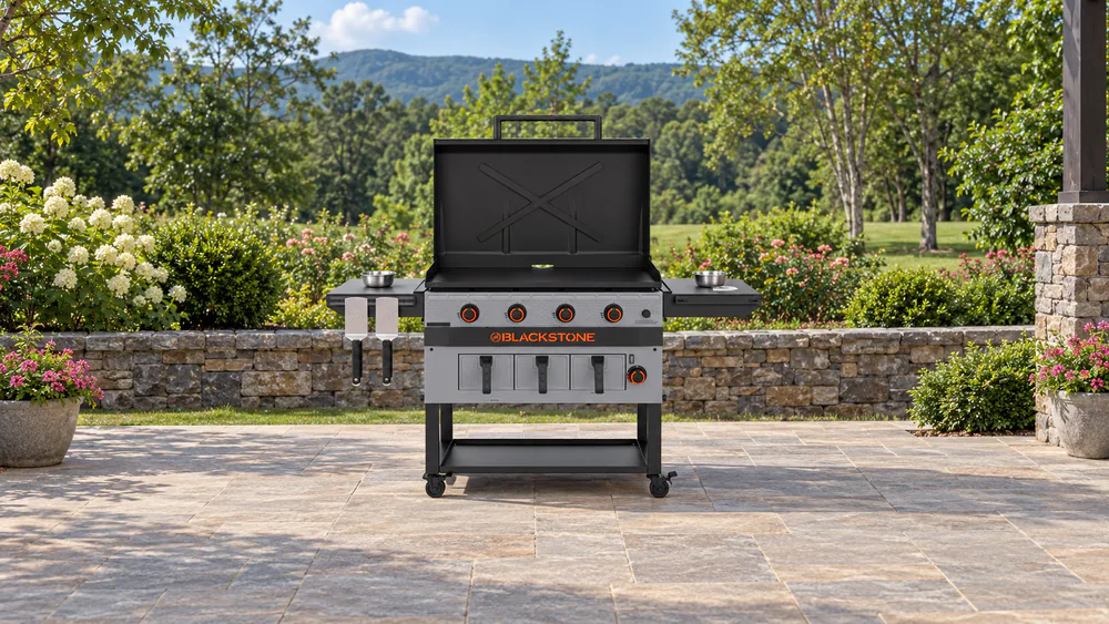 Blackstone Bronco 36 inch griddle air fryer combo with its dual side shelves loaded with prep bowls and tools on a magnetic toolbar