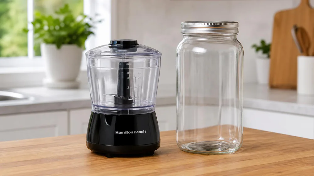 The Hamilton Beach Power Elite 3-cup mini chopper beside the 40-oz glass jar.
