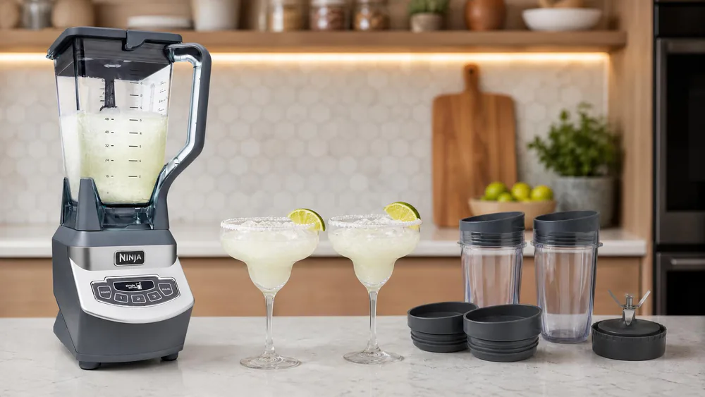 Two frozen margaritas poured from a Ninja BL660 blender, fine chopped ice visible in the glasses with no large chunks.