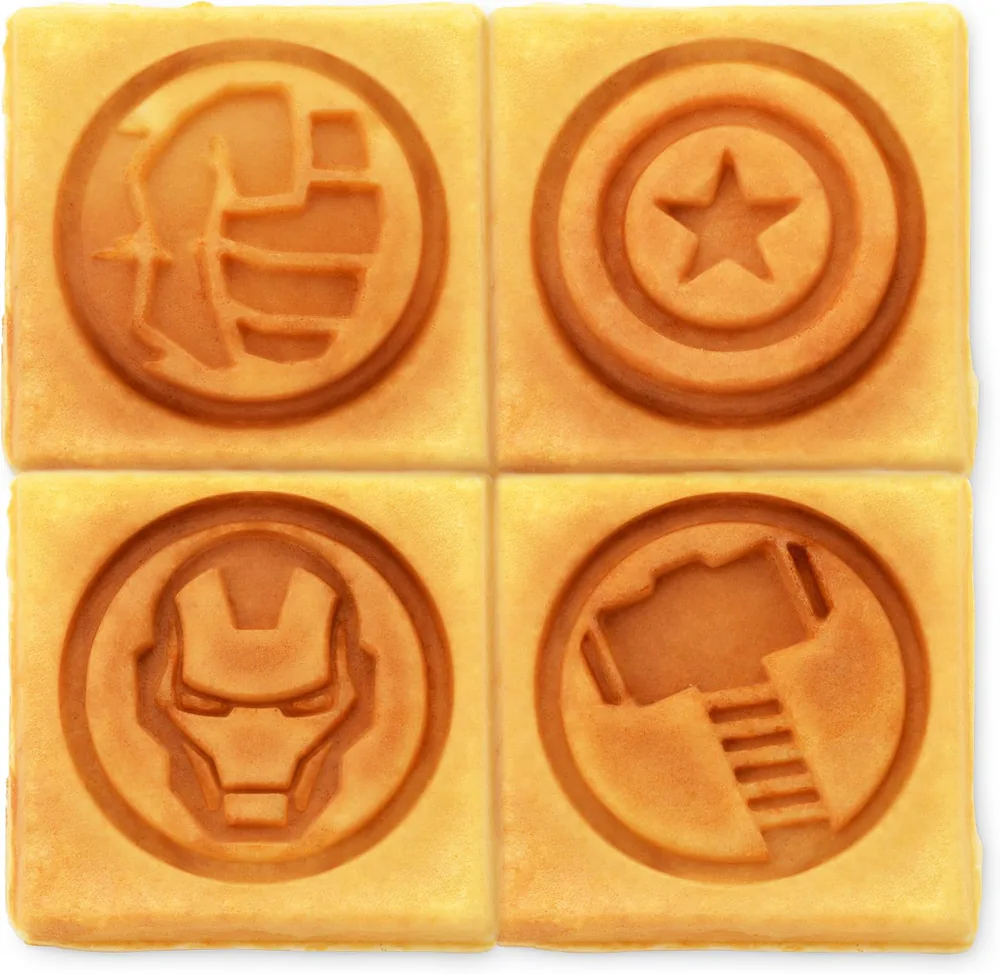 Four square waffles stamped with the Hulk fist, Captain America shield, Iron Man helmet and Thor hammer in the manufacturer product photo