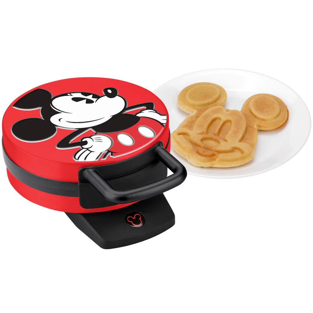 Select Brands red Mickey Mouse waffle maker beside a Mickey-shaped waffle on a white plate