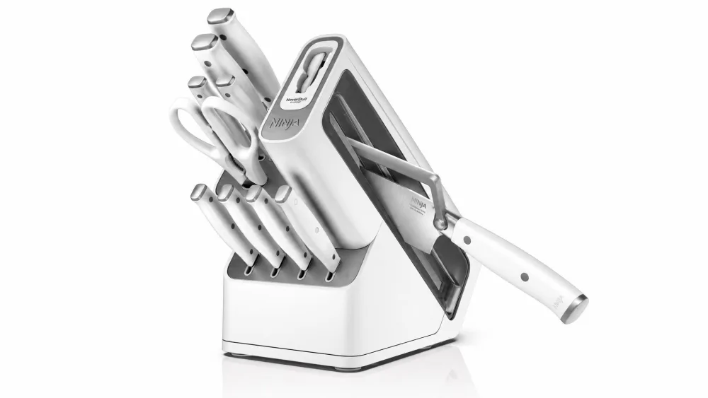The Ninja NeverDull knife block with its built-in sharpening lever engaged on a chef's knife.