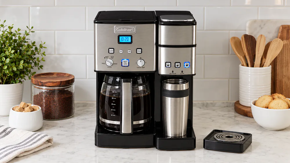 A Cuisinart SS-15P1 Coffee Center with the glass carafe on one side and a travel mug under the single-serve spout on the other