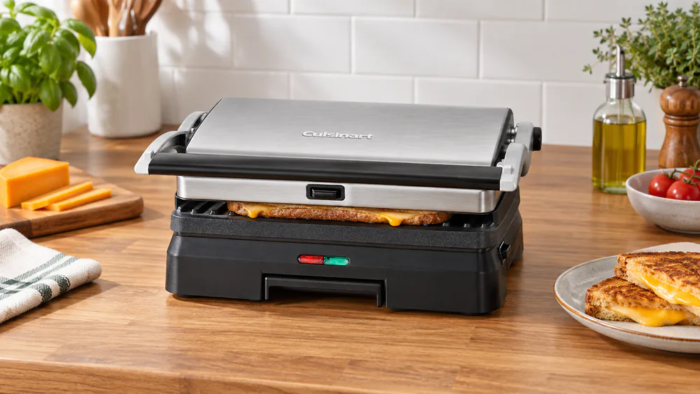 A Cuisinart GR-11 3-in-1 closed on a grilled cheese sandwich with melted cheese at the edges