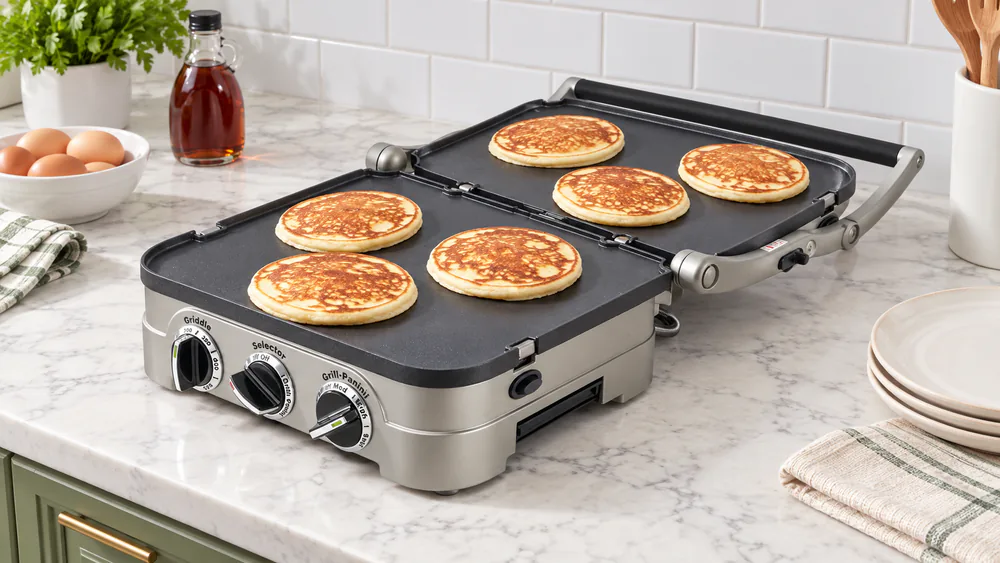 Golden pancakes cooking on the smooth griddle side of a Cuisinart GR-4N Griddler opened flat