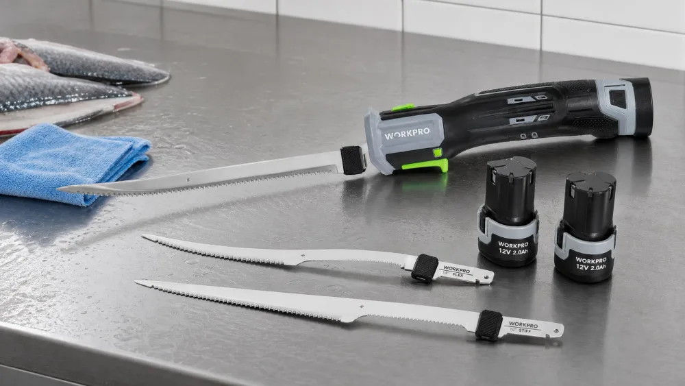 The WORKPRO 12V electric fillet knife beside its two battery packs and 8-inch flex and 10-inch stiff blades on a cleaning table.