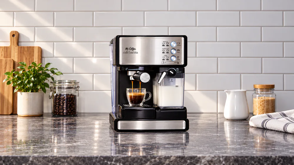 Mr. Coffee Espresso and Cappuccino Machine with a double-shot filter in place and espresso dripping into a small glass cup
