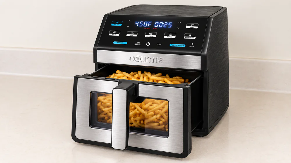 The Gourmia GAF858 8 quart air fryer with its basket pulled open and loaded with golden frozen fries, blue-light display glowing