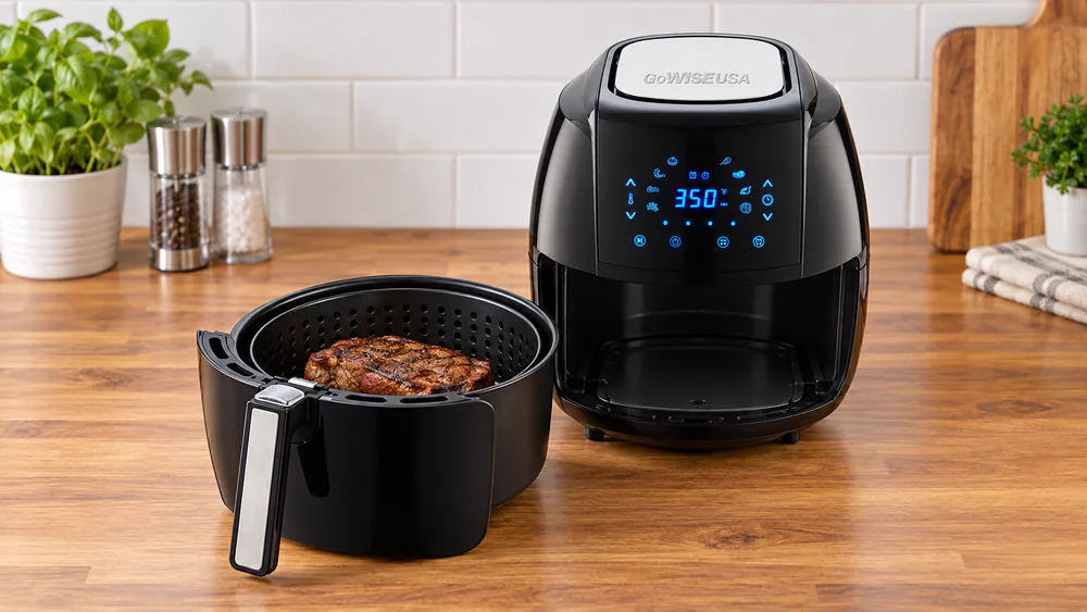 A seared steak sitting in the non-stick basket of a GoWISE 5.8-quart air fryer, browned outside with no smoke in the kitchen