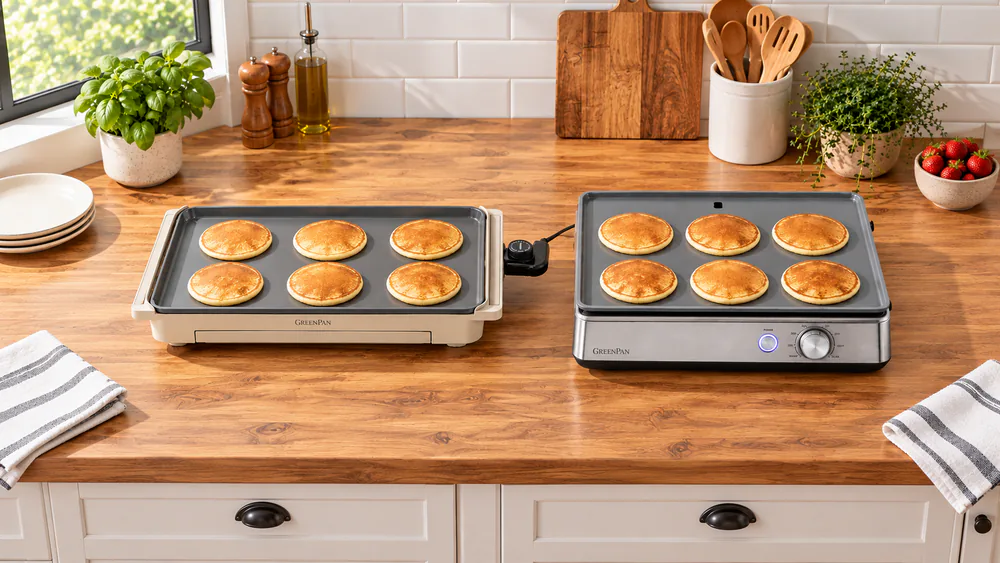Two electric griddles side by side on a counter, a long 10.5 x 20 inch plate and a squarer 16.5 x 13 inch plate, each holding the same number of pancakes