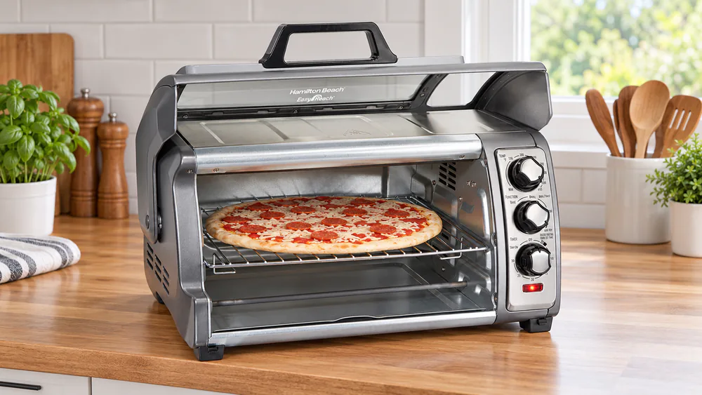 Hamilton Beach Easy Reach 31523 with its roll-top door raised and a frozen pizza on the rack inside