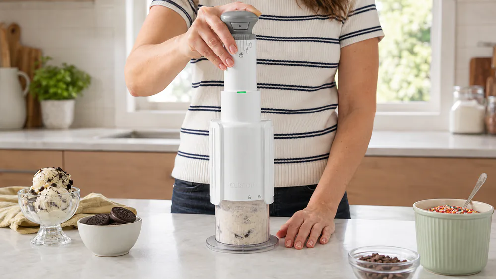 The Cuisinart FastFreeze MAX wand above a pint cup of creamified ice cream.