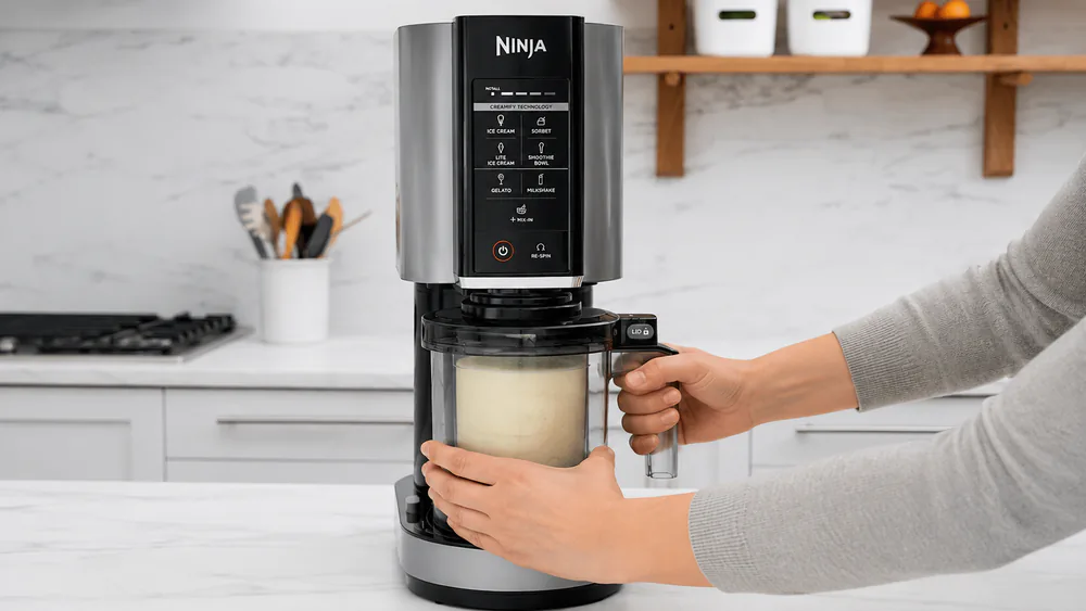 The Ninja CREAMi NC301 locking a frozen 16-ounce pint into its base.