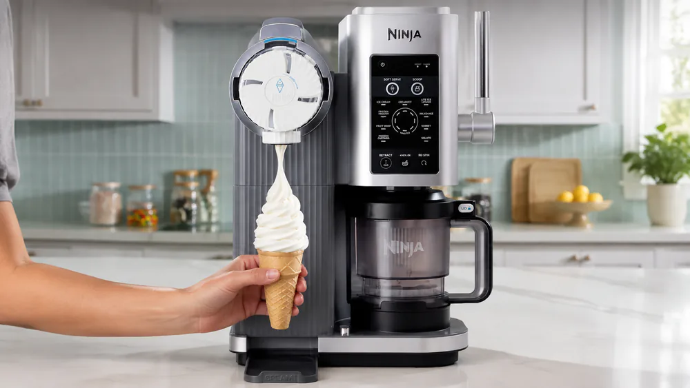 The Ninja Creami Scoop & Swirl NC701 dispensing a swirl of soft serve from its automatic handle into a cone.