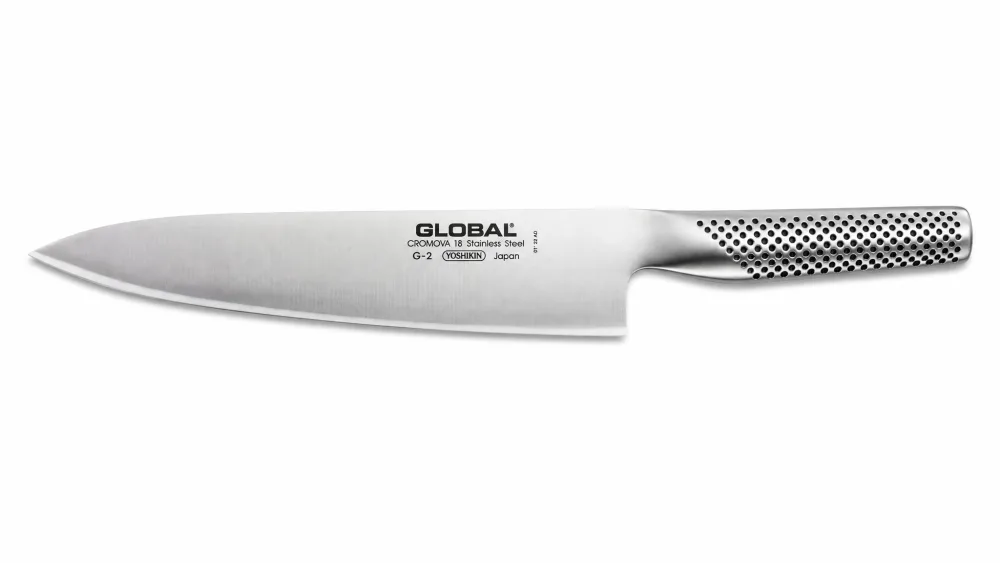 A Global G-2 chef's knife showing the seamless dimpled steel handle and blade reading as one piece.