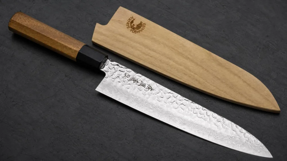 The Yoshihiro 46-layer Damascus gyuto with its octagonal wa handle and magnolia saya.