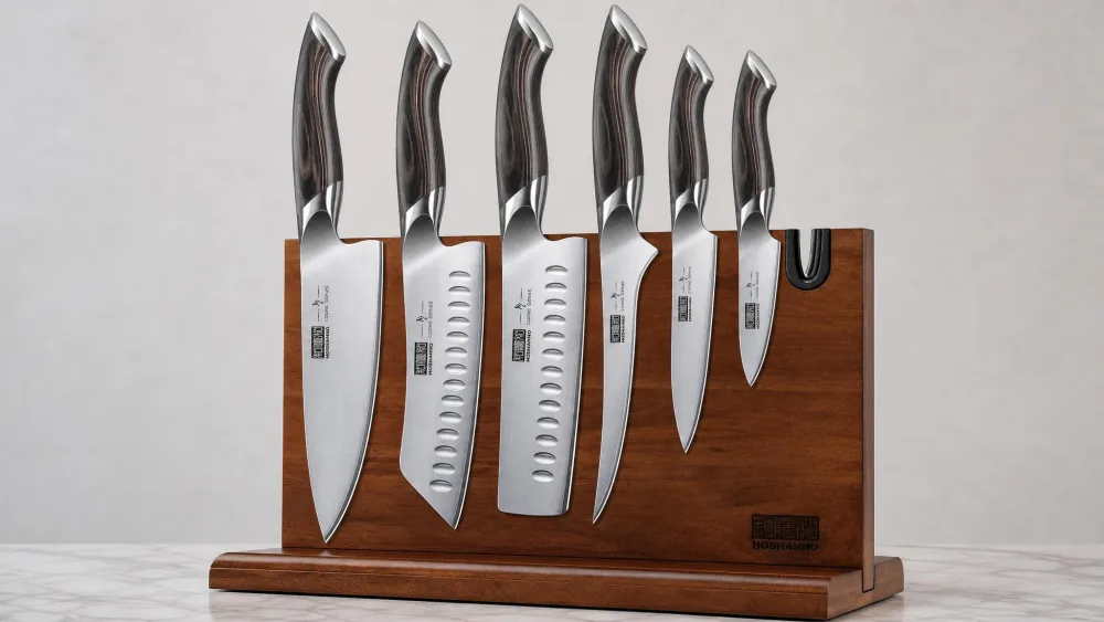 The HOSHANHO 7-piece set stored on its double-sided acacia wood magnetic board, chef, santoku, and nakiri hanging blade-up.