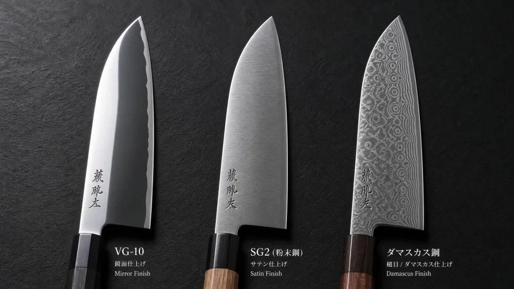 Three Japanese knife blades showing different steel finishes, a mirror-finished VG-10 blade, a powder-steel SG2 blade, and a Damascus-patterned blade, side by side.
