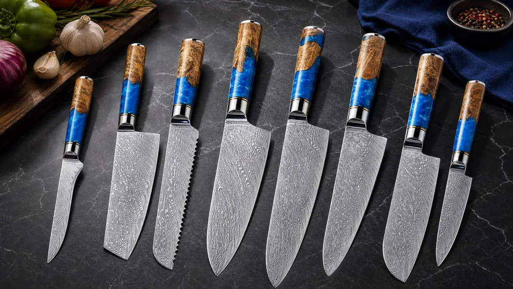 The SENKEN Tsunami 7-piece Damascus set laid on a counter, blue resin burl wood handles and folded steel patterns catching the light.