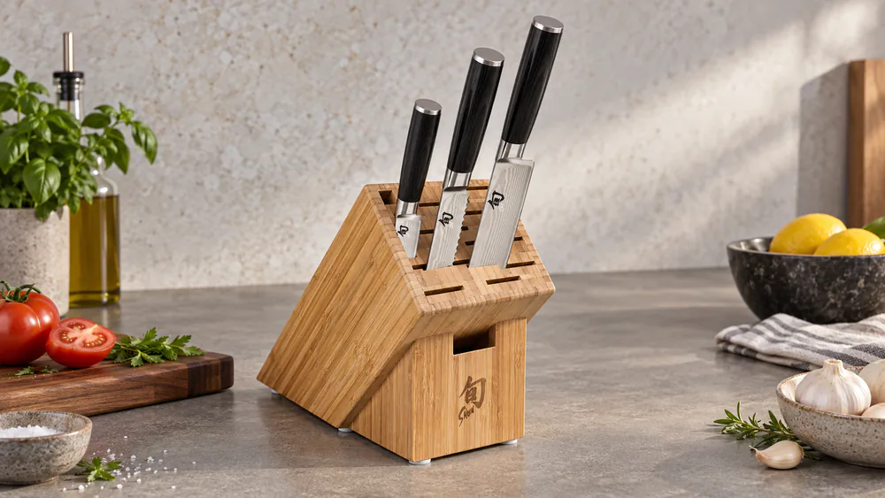 Material The Knives + Stand on a counter, three knives held magnetically on the wooden stand, both sides visible.