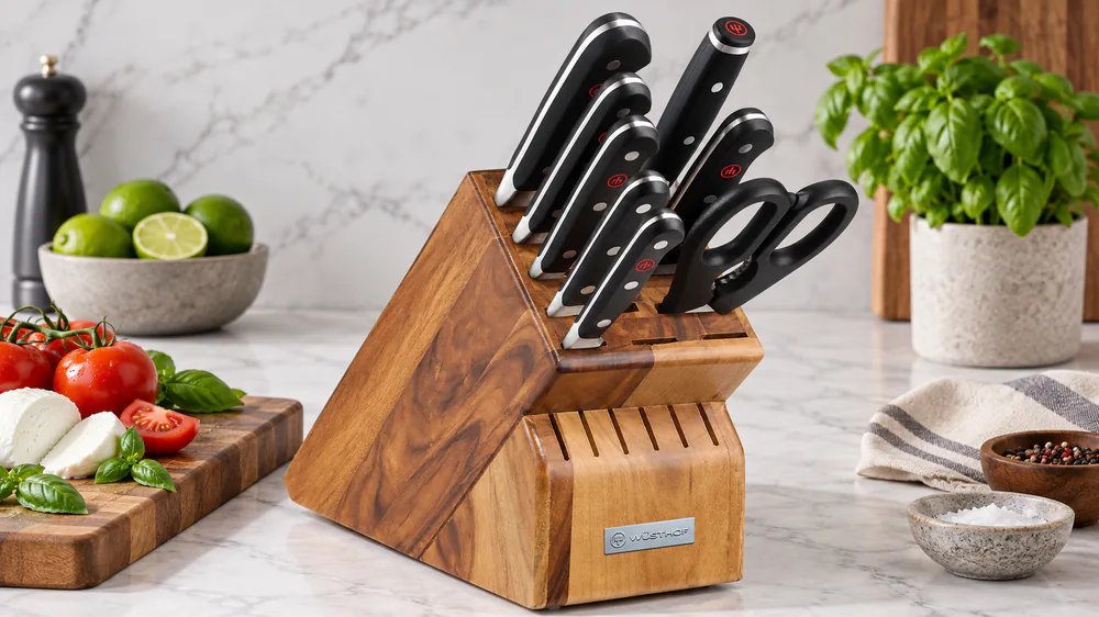 The Wüsthof Classic 9-piece acacia block with chef's, bread, and honing steel in its slots.