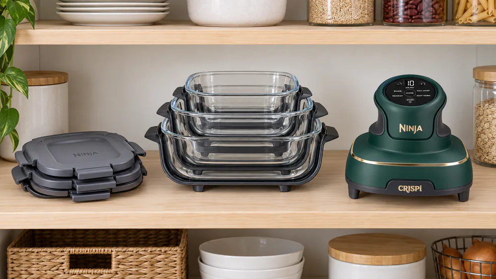 The Ninja Crispi 5-in-1's three glass containers with snap-lock lids nested into one stack beside the PowerPod on a pantry shelf.