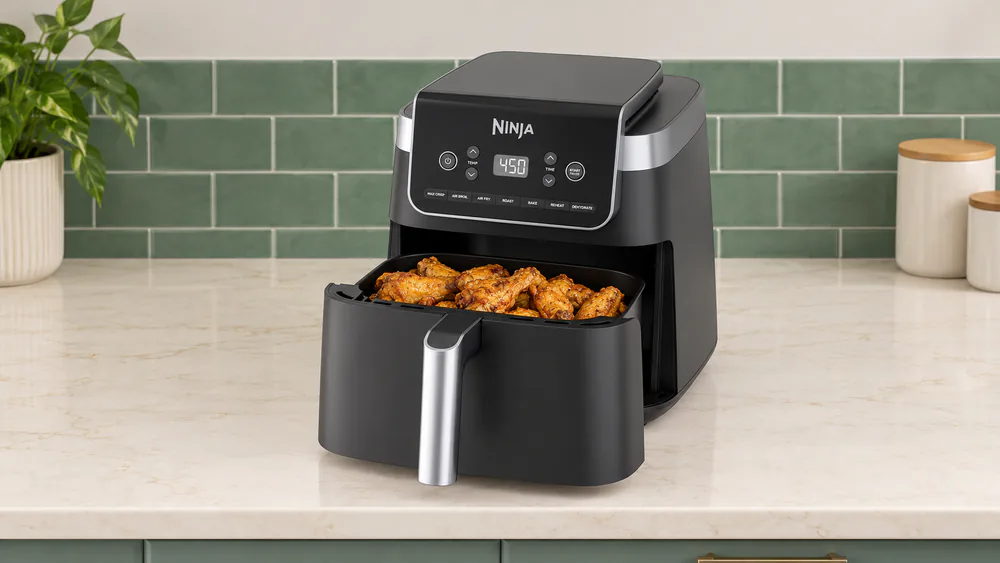Ninja Air Fryer Pro XL AF182 with its 6.5 qt basket pulled out, filled with crispy golden chicken wings