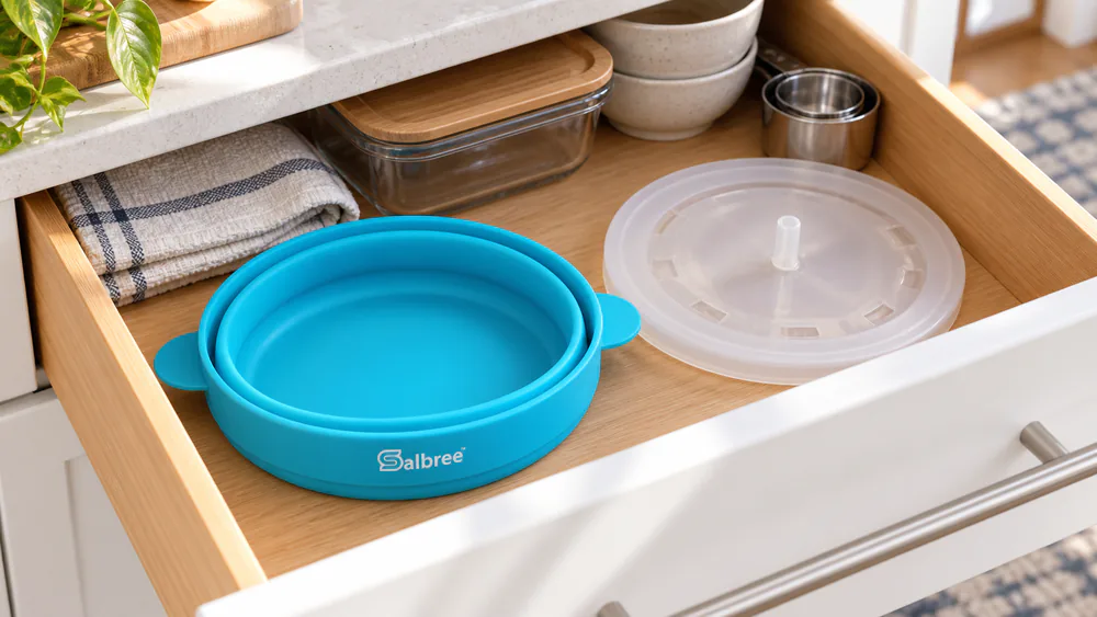 A Salbree silicone bowl folded flat in a kitchen drawer.