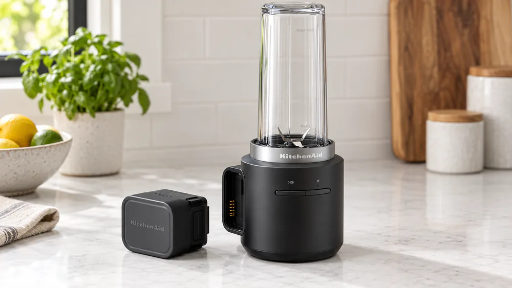 A KitchenAid Go with its 12V MAX battery slid out of the base.