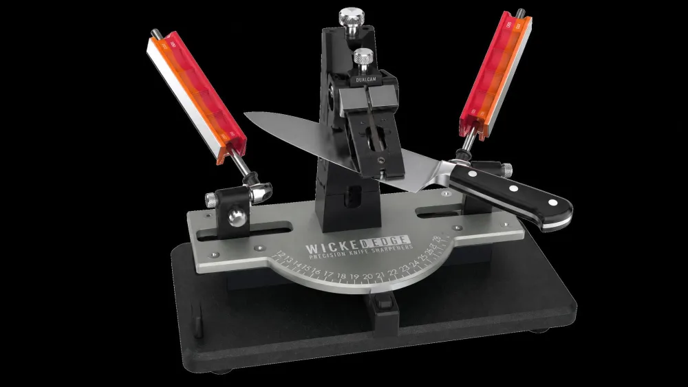 A Wicked Edge Generation 4 Pro with a chef's knife held in the DualCam vise, guide rods and diamond stones on both sides of the blade.