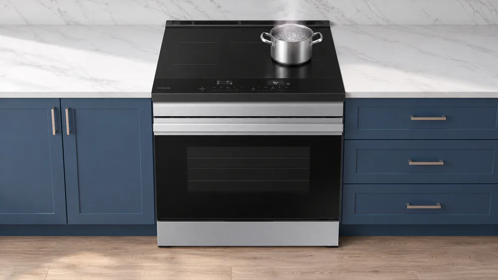 A pot of water at a rolling boil on the matte glass cooktop of a Samsung Bespoke induction range