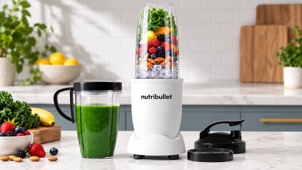 NutriBullet Pro 900 with a tall cup of green smoothie.