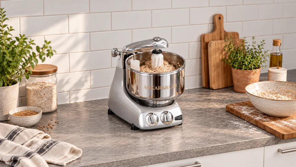 Ankarsrum Original with its rotating stainless bowl, dough roller, and scraper working a wet whole-grain dough