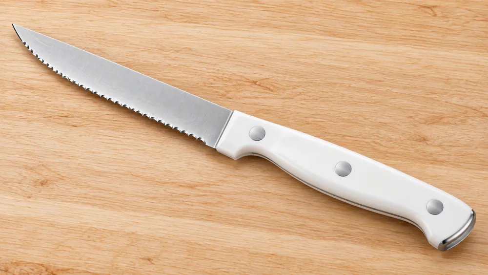 Cuisinart triple-rivet steak knife showing the ergonomic handle and wide safety bolster.