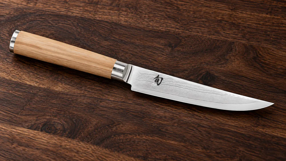Close-up of the Shun Classic Blonde showing the 68-layer Damascus cladding pattern.