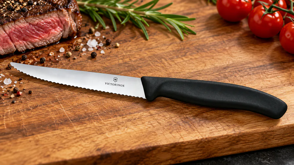 Close-up of the Victorinox Swiss Classic wavy serrated edge showing the gentle wave pattern.