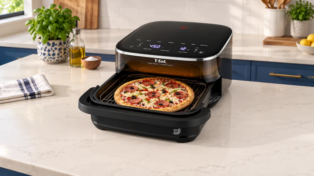 A T-fal Surface XXL air fryer with its drawer open and a frozen pizza sitting on the wide square stainless rack