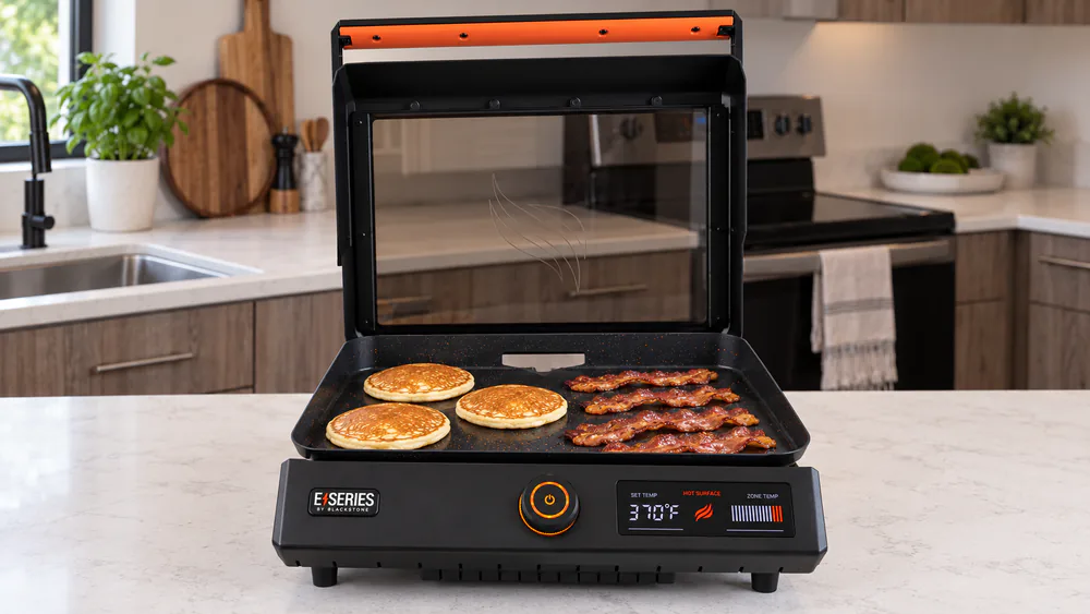 Pancakes and bacon strips cooking on the ceramic non-stick surface of the Blackstone E-Series 17-inch electric griddle