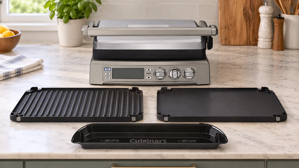 Cuisinart Griddler Elite with the reversible grill and griddle plates removed beside the plastic drip tray on a kitchen counter