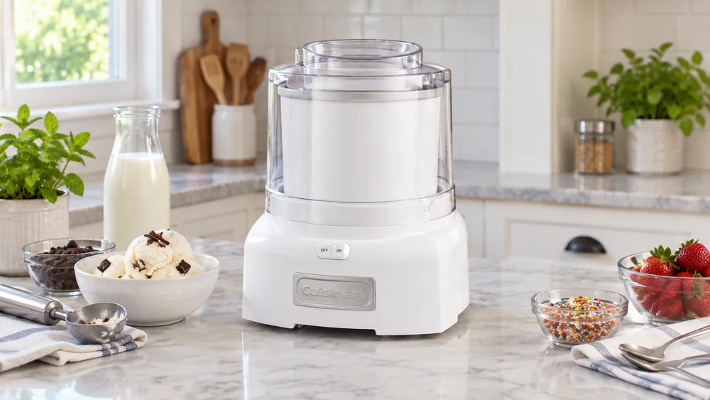 A fully assembled Cuisinart ice cream maker on a counter with the freezer bowl seated, paddle centered, and the easy-lock lid clicked into place, pour spout facing forward.