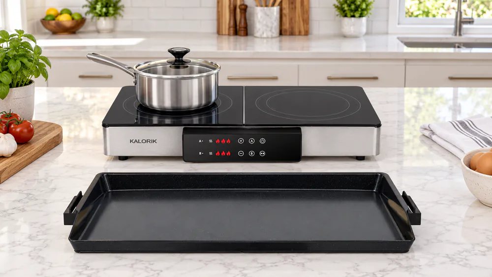 The two exposed Kalorik MAXX burners with the griddle plate lifted off and a saucepan sitting on the left zone