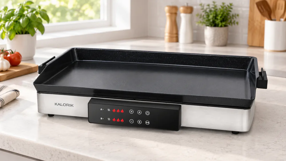 The Kalorik MAXX 22-inch teppanyaki griddle plate seated on its stainless steel body on a kitchen counter
