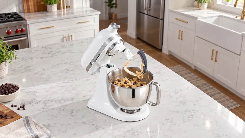 Chocolate chip cookie dough in the 3.5-quart stainless bowl of a KitchenAid Artisan Mini with the flex edge beater attached