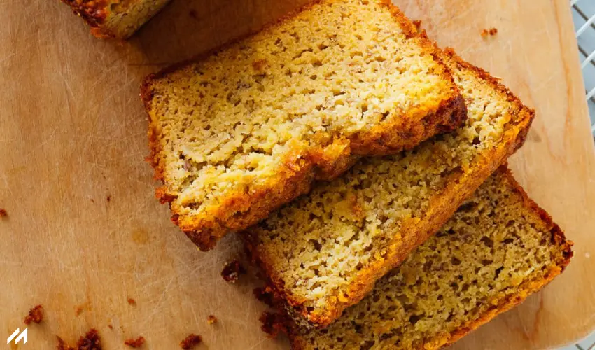 Almond Flour Banana Bread (Gluten-Free) Slices of golden, fluffy cornbread stacked on a wooden cutting board, with a crispy crust and moist, crumbly interior.
