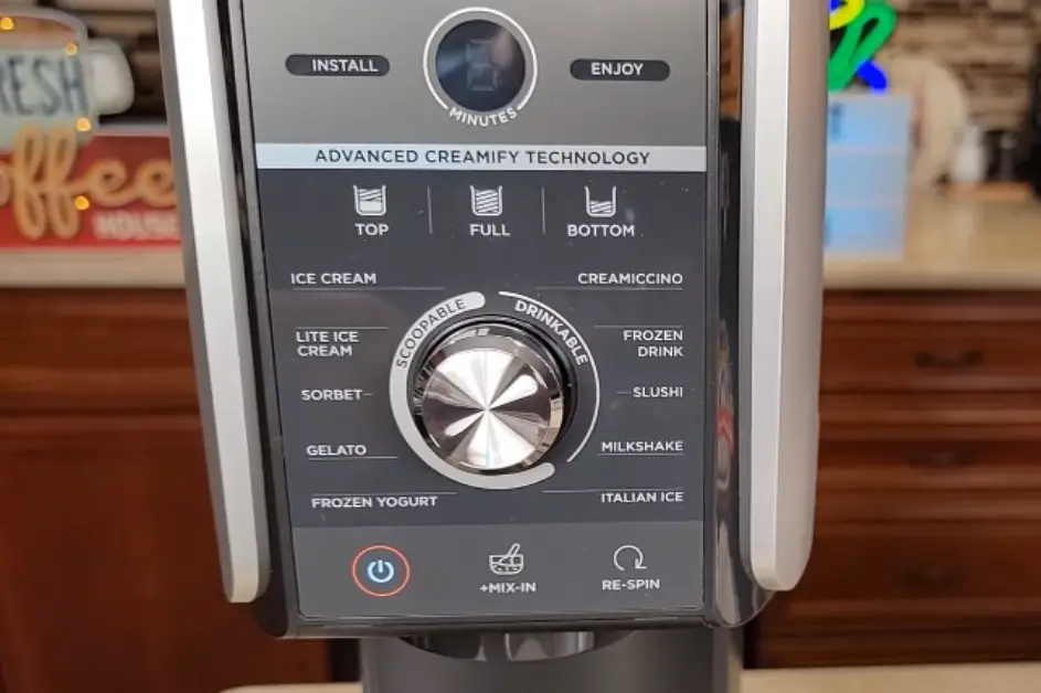 Close-up of a sleek Ninja Creami ice cream maker control panel, showcasing various settings for ice cream, sorbet, and frozen drinks.