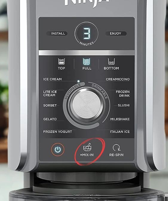 Ninja Creami Deluxe Mix-In Function Close-up of a Ninja ice cream maker's control panel, highlighting the "+MIX-IN" button for adding ingredients.