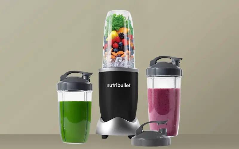 Nutribullet 900 Blender Review Nutribullet 900 Blender with large servings of smoothies and additional cups.