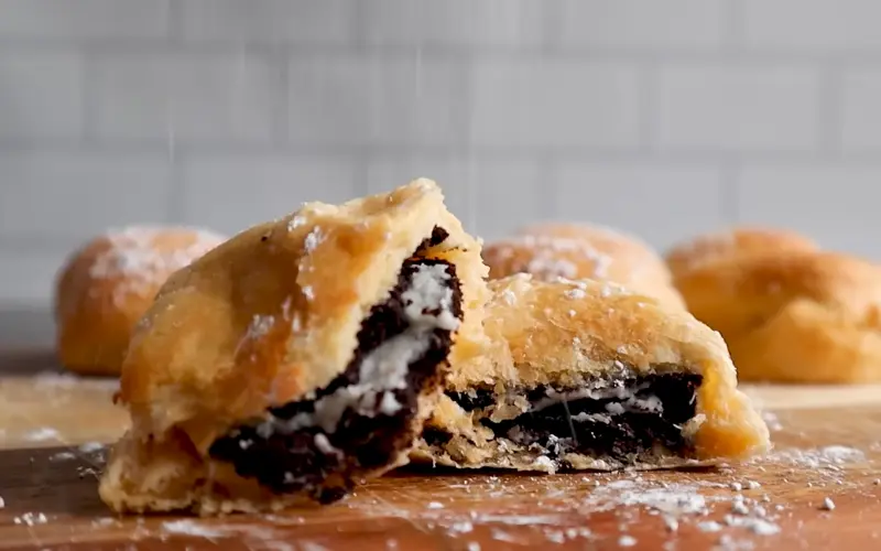 Air Fried Oreos Golden crispy air fried Oreos dusted with powdered sugar showing chocolate cookie and cream filling inside