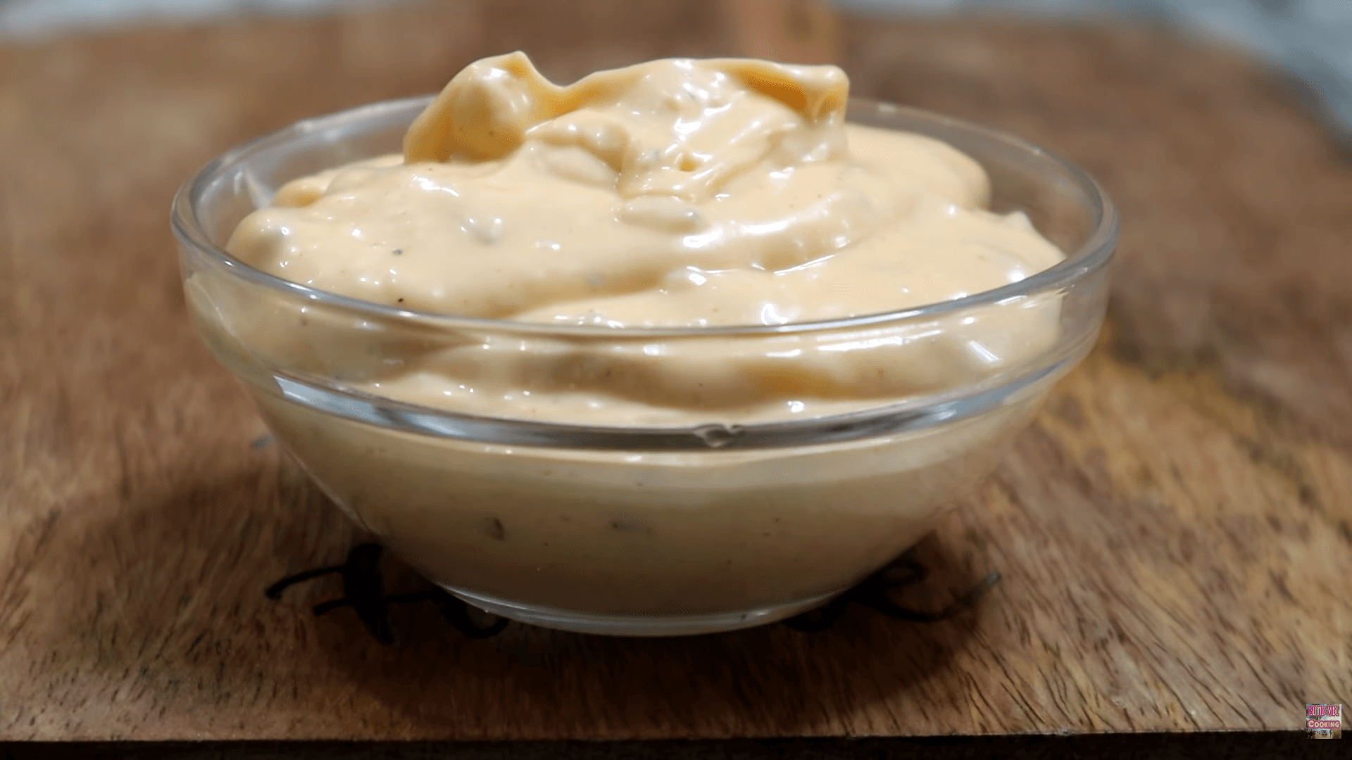 Homemade Big Mac sauce in a white bowl surrounded by copycat recipe ingredients including Hellmann's mayo, sweet pickle relish, yellow mustard, paprika, and turmeric on a marble surface